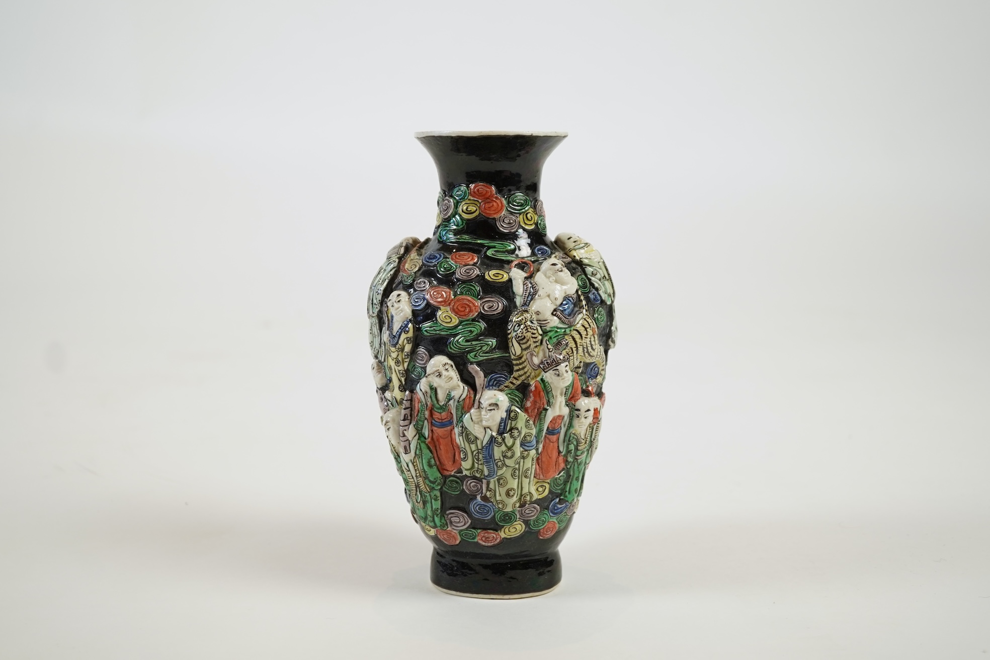 A Chinese enamelled biscuit ‘eighteen Luohan’ vase, 19th century